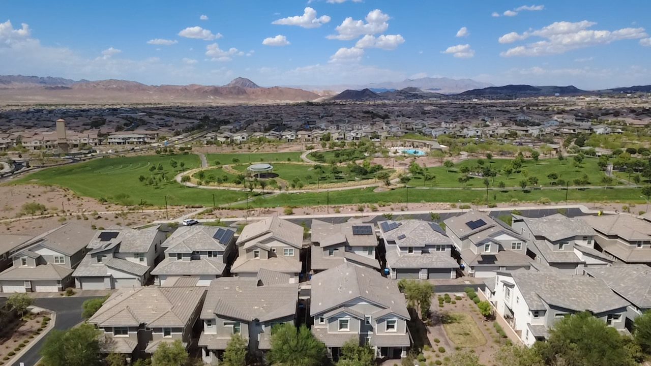 Aerial drone view of Las Vegas neighborhood with park and mountain backdrop