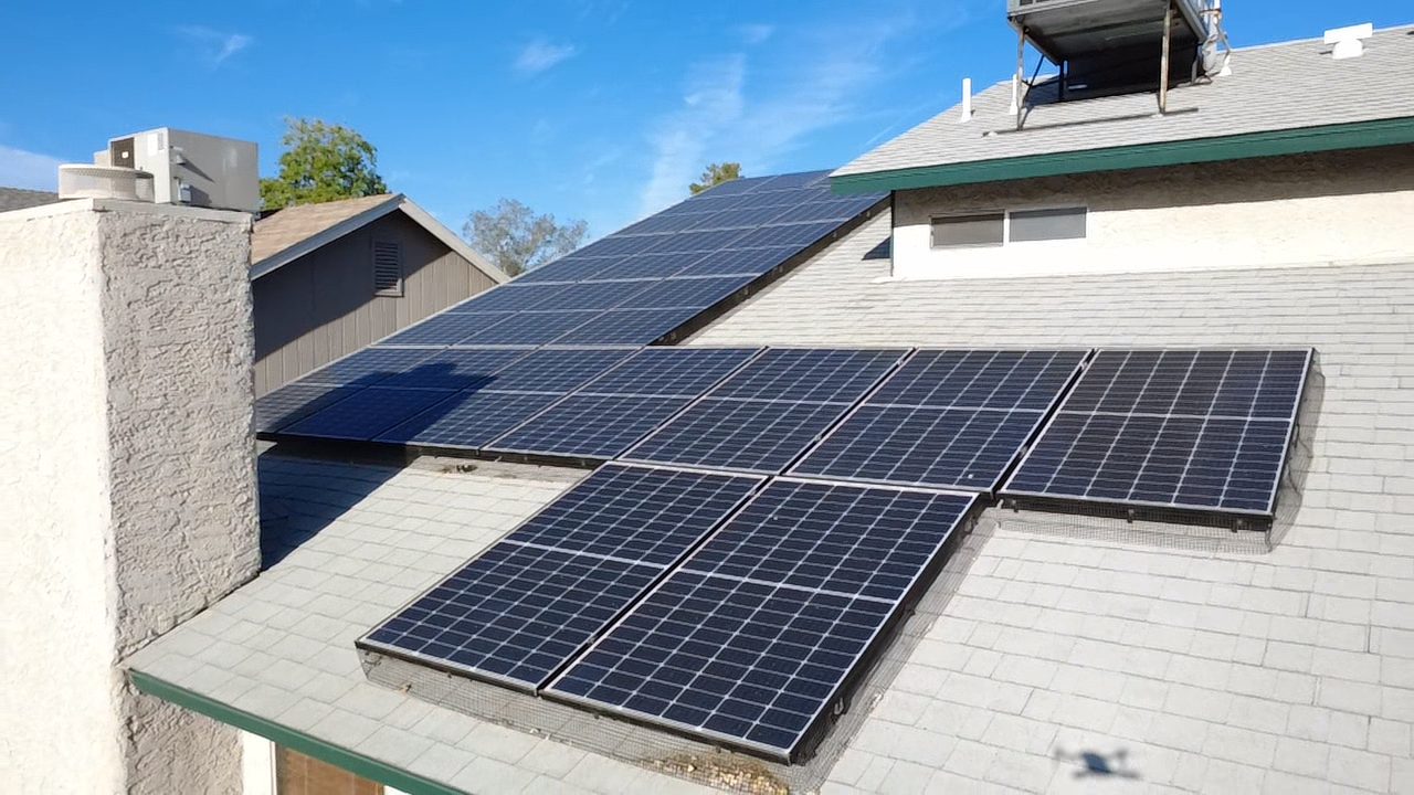 Aerial drone view of residential rooftop solar panel system in Las Vegas